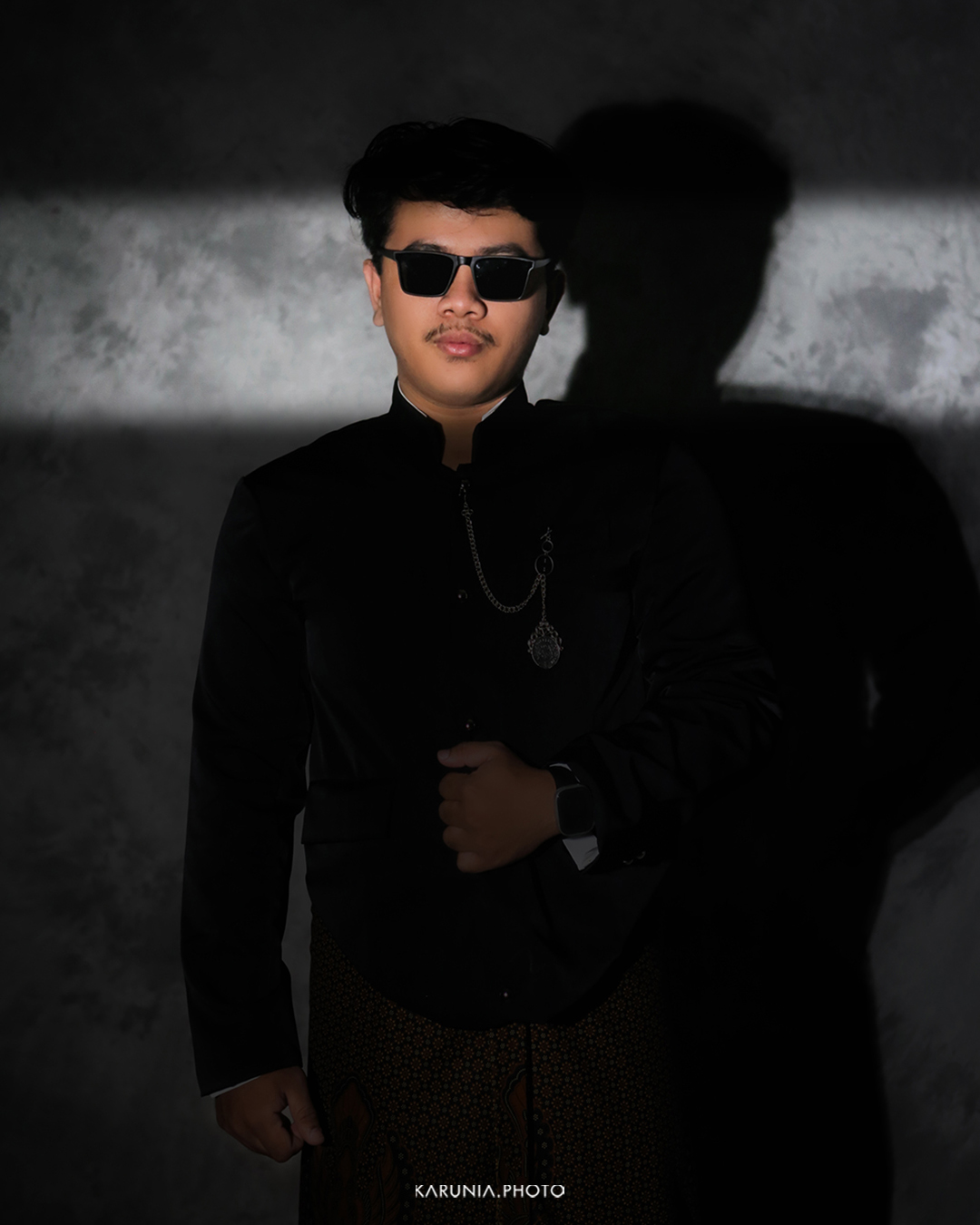 Artistic portrait with creative lighting effects casting geometric shadows across the subject's face